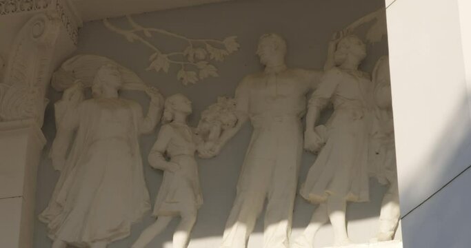 Depiction of family in a high relief form, created in socialist realism style.