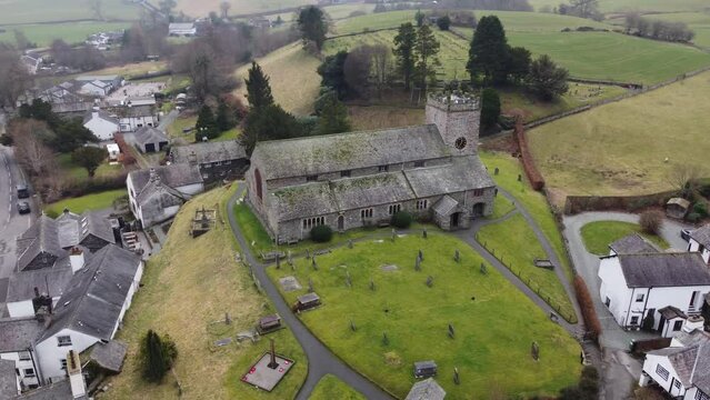 Cinematic aerial drone footage of Hawkshead Village and St Michael and All Angels Church.Cumbria UK.