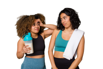 Two best friends are ready to go to the gym, one of them holds a protein shake, being shocked, she has remembered important meeting.