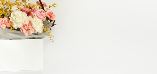 box with white and pink flpwers on white background.