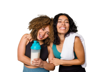 Two best friends are ready to go to the gym, one of them holds a protein shake, laughing and having fun.