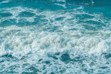 Background with sea waves. White foam on the surface of the water.