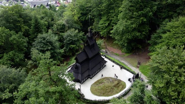 Drone shot descending towards the Stave church cloudy day in Fantoft, Norway