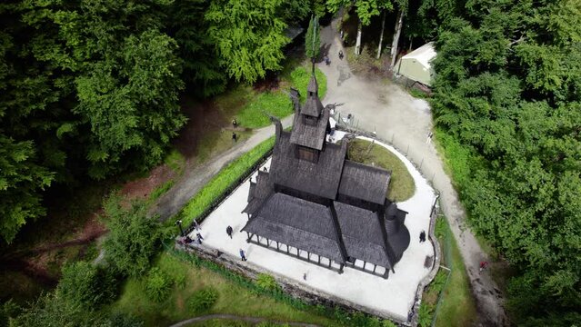Aerial view around the Stave church in sunny Fantoft, Norway - high angle, orbit, drone shot