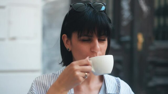 Female Taking A Sip Of Coffee