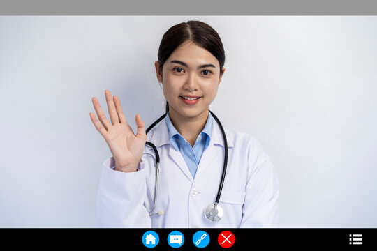 telemedicine online video call, Young female doctor in white coat with stethoscope, looking at camera and smiling.