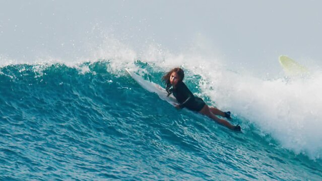 Surfers pass big upcoming wave