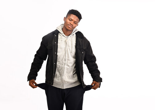 No Money. Portrait Of Frustrated Stressed Poor Man In Black Denim Casual Shirt Showing Empty Pockets Inside Out, Going Bankrupt, No Cash For Living. Indoor Studio Shot Isolated On Yellow Background