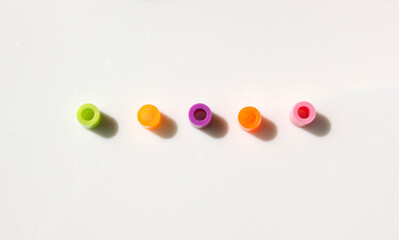Pieces of colorful plastic beads isolated white background