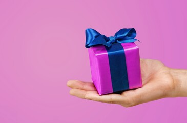 Human hands holding a gift box