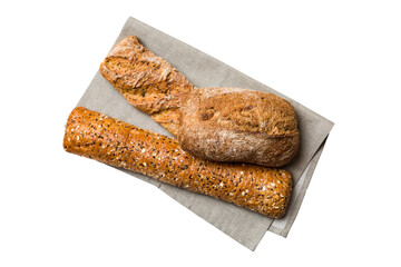 Freshly baked delicious french bread with napkin isolated on white background top view. Healthy white bread loaf