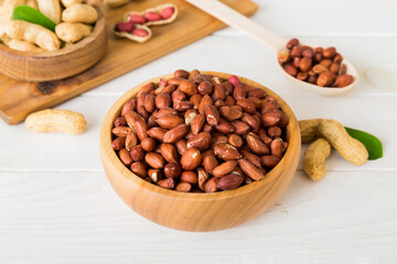 Fresh healthy peanuts in bowl on colored table background. Top view Healthy eating bertholletia concept. Super foods