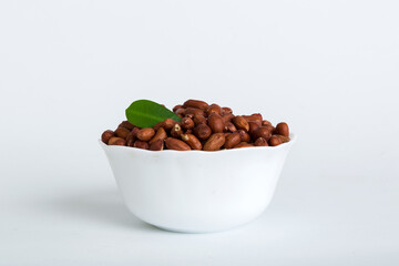 Fresh healthy peanuts in bowl on colored table background. Top view Healthy eating bertholletia concept. Super foods