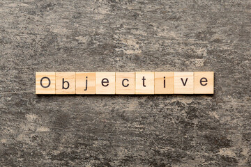 objective word written on wood block. objective text on table, concept