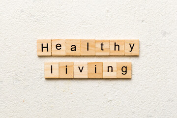 Healthy Living word written on wood block. Healthy Living text on cement table for your desing, concept