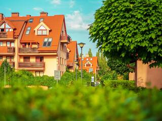 outside of cozy apartment complex, facade view in a summer sunny day