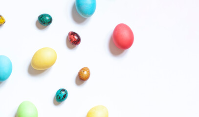 Colorful painted Easter eggs on the white background. Top view. Copy space