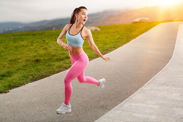 Happy runner young woman exercising outside