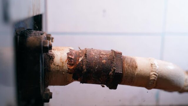 Heating pipe, place of attachment to a solid fuel boiler. The metal pipe was corroded after a leak. Water heating at home in winter