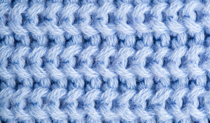 Background of knitted fabric with a pattern. Weaving winter clothes close-up.