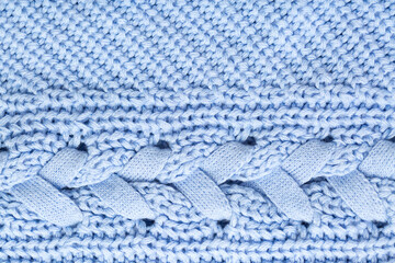 Background of knitted fabric with a pattern. Weaving winter clothes close-up.