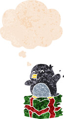cartoon penguin on present and thought bubble in retro textured style
