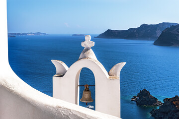 White bell tower in Oia. Santorini, Greece.