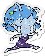 distressed sticker of a cartoon crying alien girl