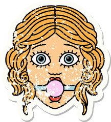 traditional distressed sticker tattoo of female face with ball gag