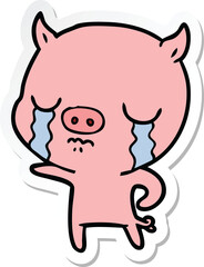 sticker of a cartoon pig crying
