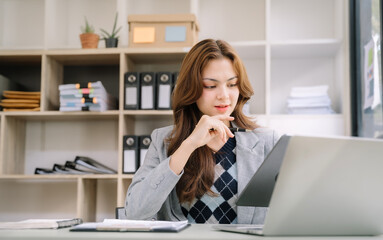 Women work on laptop on the table at the office with information documents.