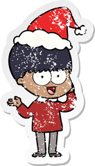 happy distressed sticker cartoon of a boy wearing santa hat