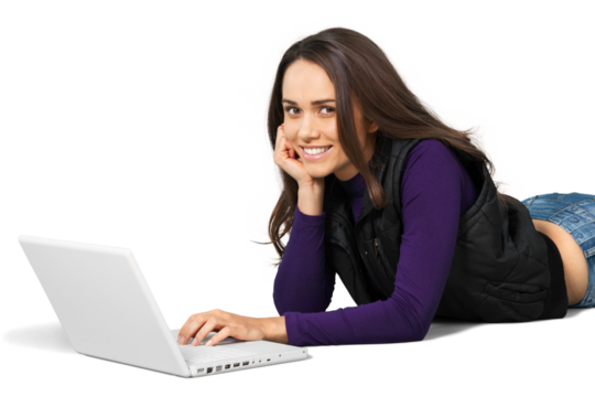 Young woman lying down in front of a laptop