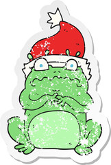 retro distressed sticker of a cartoon frog in christmas hat