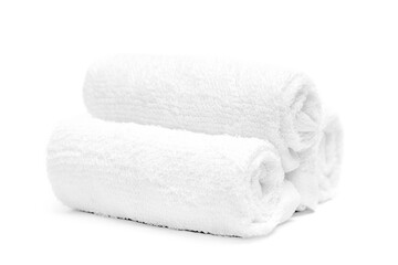 Fototapeta na wymiar Rolled up spa towels. Folded soft terry towels isolated on white background. Three clean white towel.