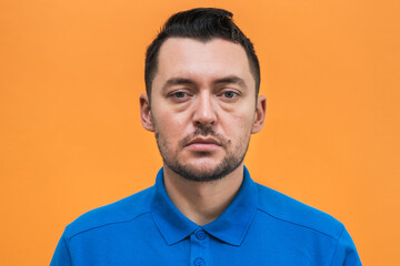 Portrait of the man on orange background. Man's emotions