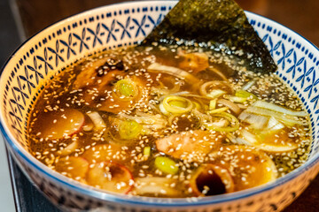 Japanese miso soup with vegetables in bowl on the table