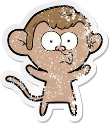 distressed sticker of a cartoon surprised monkey