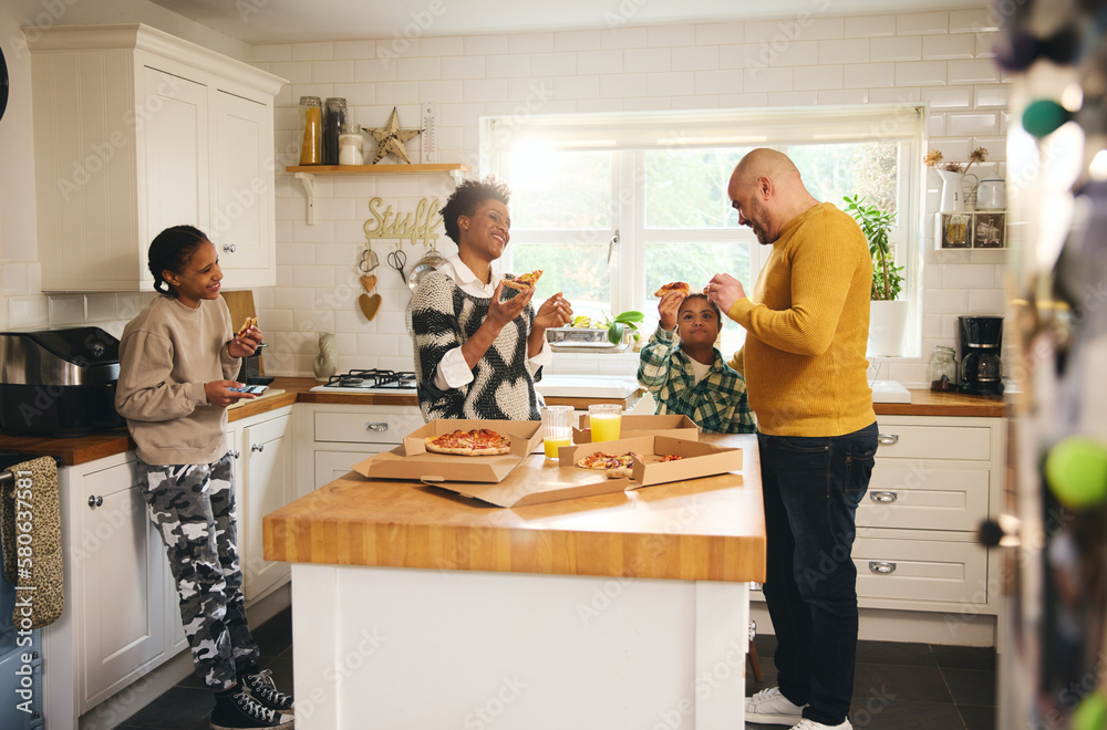 Wall mural Family with boy with Down syndrome enjoying takeaway pizza for dinner