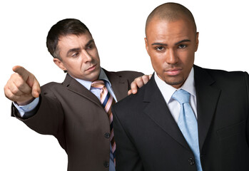 One businessman pointing and looking sternly at another businessman