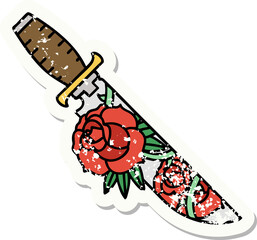 traditional distressed sticker tattoo of a dagger and flowers
