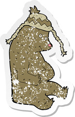 retro distressed sticker of a cartoon bear in winter hat