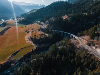 Photo sur Plexiglas Viaduc de Landwasser Aerial view of Train passing through famous mountain in Filisur, Switzerland. Landwasser Viaduct world heritage with train Glacier express in Swiss Alps.
