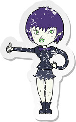 retro distressed sticker of a cartoon vampire girl giving thumbs up sign