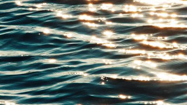 Water surface with flares at sunset