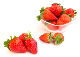 fresh appetizing strawberries in a glass bowl on white background