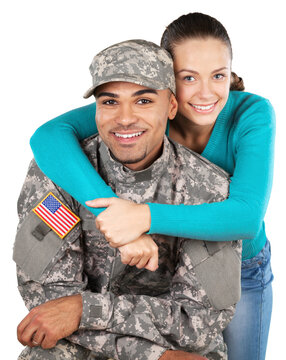 Smiling soldier with his wife standing against white background
