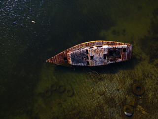 old rusty abandoned yacht on the seashore