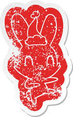 cute cartoon distressed sticker of a rabbit dancing wearing santa hat