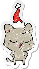 happy distressed sticker cartoon of a cat wearing santa hat